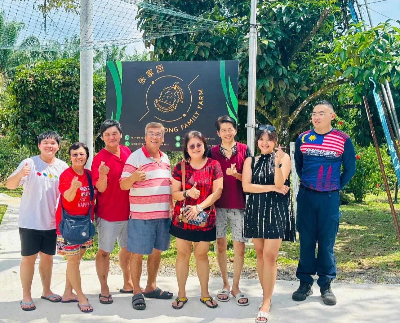 A group posing beside the Cheong Family Farm sign.